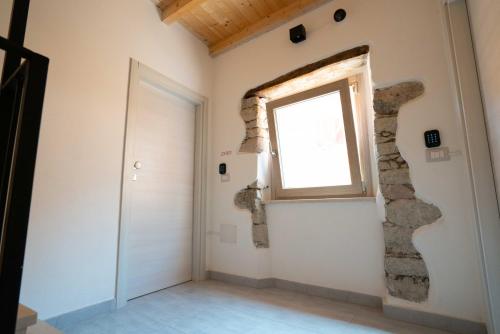 a room with a window and a door at Casa Mirto in Bosa