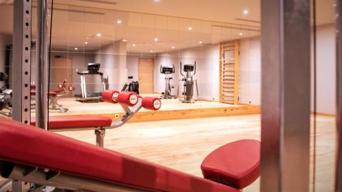 a gym with red equipment in a room at Hôtel Le Diamond Rock in Tignes