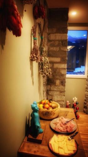 a table with a bowl of fruit and a bowl of food at Ca' De Sass in Pila
