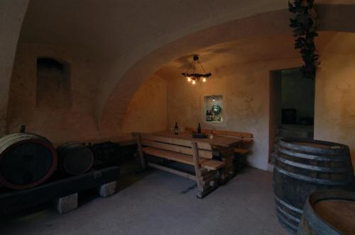 a room with a wooden table and barrels in it at Ferienhaus Marienkeller in Leibnitz