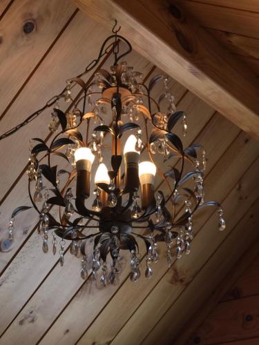 a chandelier hanging from a ceiling in a room at Comfort and Style in this Petone Townhouse in Lower Hutt