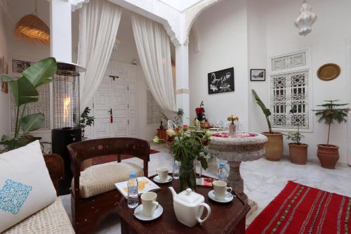 a living room with a table and a couch at Riad Morocco Sky in Marrakesh