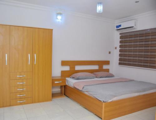 a bedroom with two beds and a dresser at Orchids Service apartments in Lagos