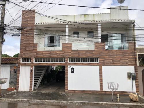 a brick house with two white doors on it at Temporada Cabo Frio in Cabo Frio