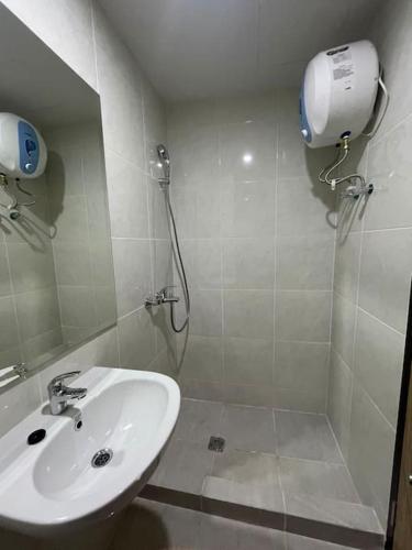 a bathroom with a shower and a sink at Delft Apartment - Sea View Studio Flat at Losari Beach in Makassar