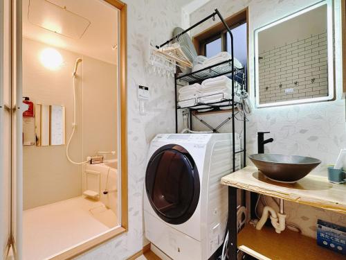 a washing machine in a bathroom with a sink at Retreat Tachibana 旅趣・橘 in Osaka