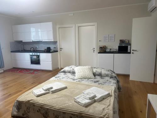 a bedroom with a bed with towels on it at Podere Belsogno-Miniappartamento Roseto in Montalcino