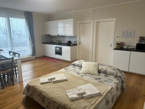 a living room with a couch and a kitchen at Podere Belsogno-Miniappartamento Roseto in Montalcino