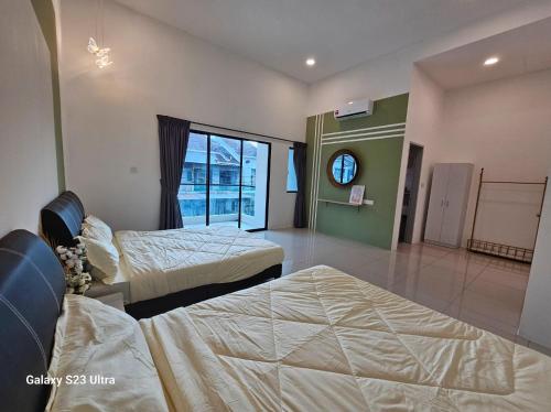 a hotel room with two beds and a window at Sunway Ipoh - DamaiStay - 5min to Tambun - 20Pax in Tambun