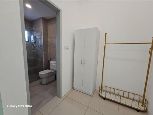 a bathroom with a toilet and a shower and a door at Sunway Ipoh - DamaiStay - 5min to Tambun - 20Pax in Tambun
