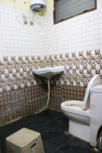 a bathroom with a sink and a toilet at Tanmay Homes and PG in Gurgaon