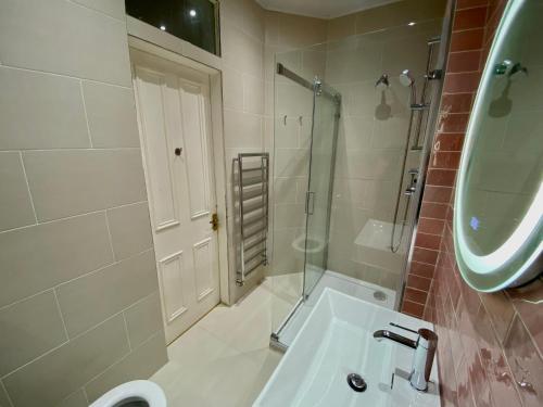 a bathroom with a sink and a shower and a toilet at Traveller Award Winner 2023 - Edinburgh Apartment with 3 Beds in Edinburgh