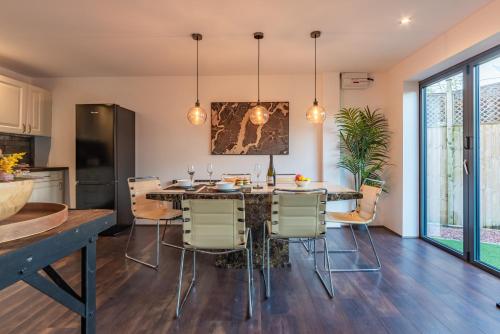 a kitchen and dining room with a table and chairs at Cotswold holiday let with hot tub - The Old Garage in Chipping Norton
