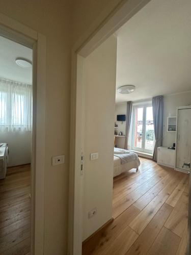 a bedroom with a bed and a room with wooden floors at Podere Belsogno in Montalcino