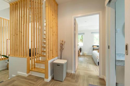 a room with a staircase and a living room at Naka Cozy House in Phuket City in Ban Rangeng