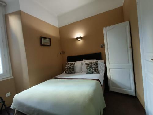 a bedroom with two beds and a door at Hotel Villa La Tour in Nice