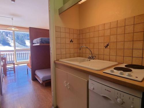 Il comprend une chambre et une cuisine équipée d'un évier et d'une cuisinière. dans l'établissement Appartement Le Dévoluy, 1 pièce, 4 personnes - FR-1-525-185, à Saint-Étienne-en-Dévoluy
