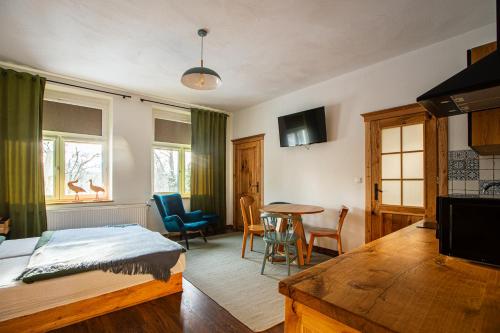 a bedroom with a bed and a table and chairs at Folwark Wierzchy in Wierzchy