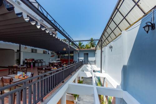 a balcony of a restaurant with tables and chairs at LuangPrabang Center Hotel in Luang Prabang