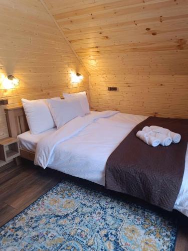 a bedroom with a large bed in a wooden room at M&M House in Ach'khoti