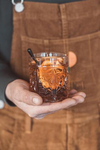 a man holding a drink in a glass at La Voie Lactée in La Mongie