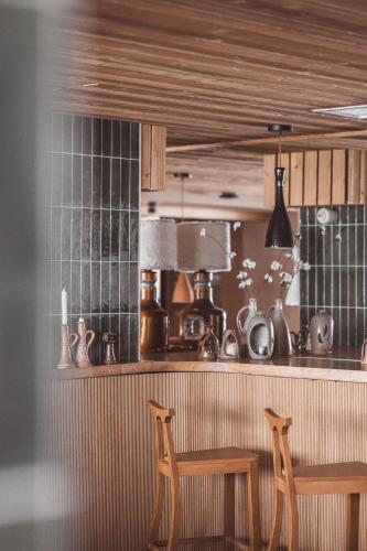 two chairs sitting in front of a kitchen counter at La Voie Lactée in La Mongie