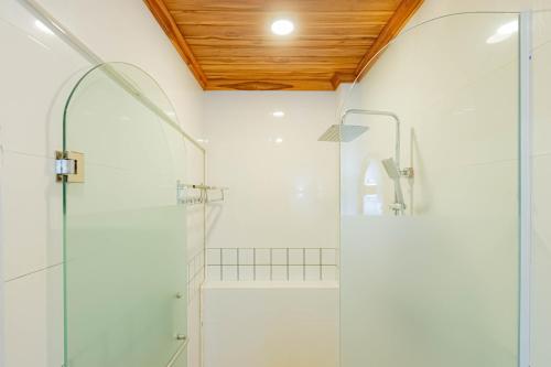 a bathroom with a shower with a glass door at LuangPrabang Center Hotel in Luang Prabang