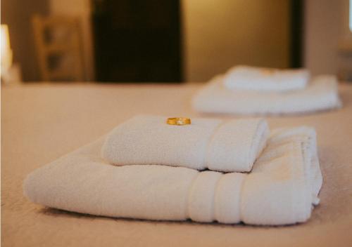 two folded towels with a ring on top of them at The Heathfield Inn in Honiton