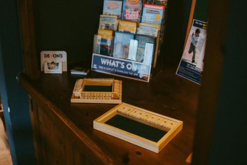 a wooden counter with two boxes on top of it at The Heathfield Inn in Honiton