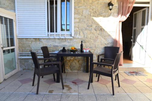 a black table and chairs on a patio at Xenios Dias in Megáli Vrísi