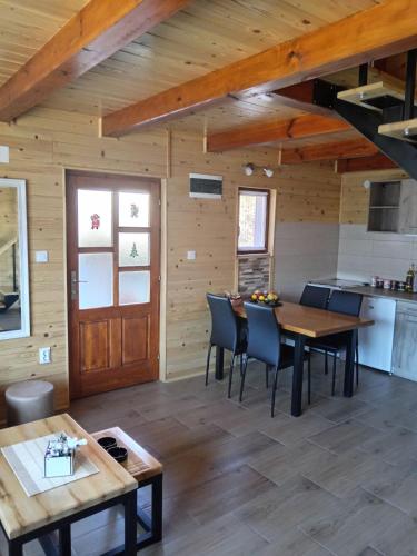 a kitchen and dining room in a log cabin at Dobar Pogled 2 in Kamenjača