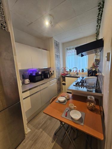 a small kitchen with a table and a stove at Cheshunt House in London