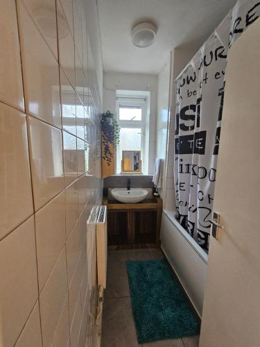 a bathroom with a sink and a mirror and a sink at Cheshunt House in London