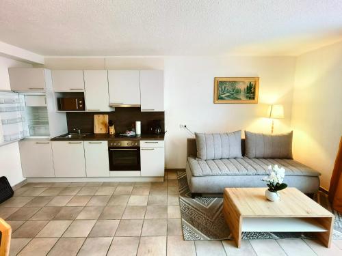 a living room with a couch and a table at Apartments Pitztaler Nachtigall in Arzl im Pitztal