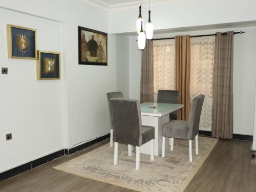 a dining room with a table and chairs at MJ Hosting in Dar es Salaam