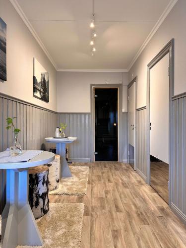an empty room with a table and a hallway at Åsbergbo Vandrarhem in Vallsta