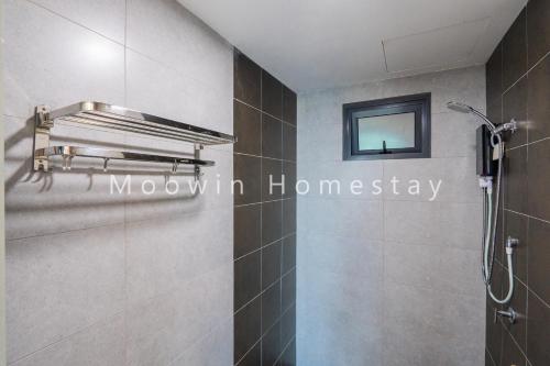 a bathroom with a shower and a mirror on the wall at Comfy Suite by Moowin in Perai