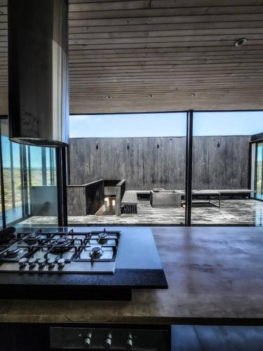 a kitchen with a stove top oven in a room at Casa Box, Punta de Lobos in Pichilemu