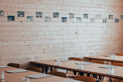 a room with tables and chairs and a wall at La Voie Lactée in La Mongie