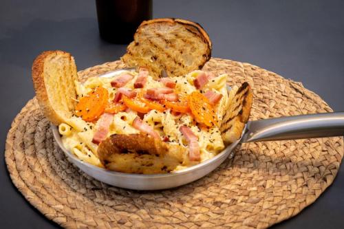 a bowl of food on a plate with bread at Ibuku Hotel Guatapé - Chalets in Guatapé
