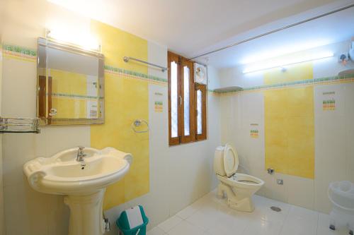 a bathroom with a sink and a toilet at Sudarshan Homestay in Jodhpur