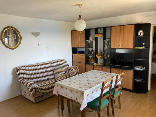 a kitchen and dining room with a table and chairs at Apartment Tina Sveti Juraj in Senj