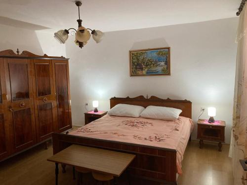 a bedroom with a large bed with two night stands at Apartment Tina Sveti Juraj in Senj