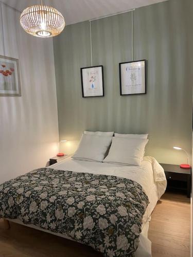 une chambre avec un lit et deux tableaux au mur dans l'établissement Marseille Côté Cour, à Marseille