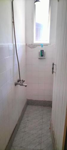 a bathroom with a shower with a window at Aurelia Nelly in Ukunda