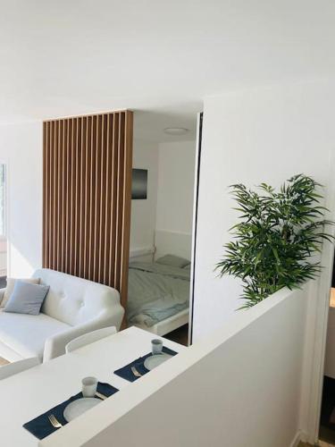a living room with a white couch and a mirror at Cozy studio + (Gratis parking) in Antwerp