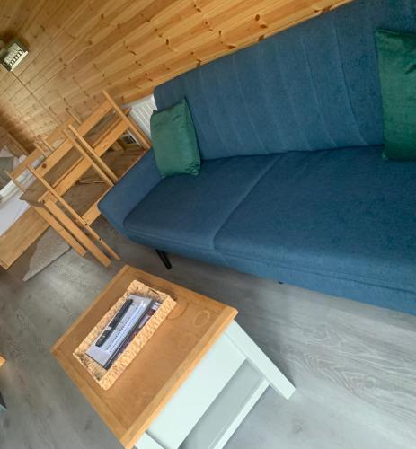 an overhead view of a blue couch and a coffee table at Dwell on the Moor in Holme upon Spalding Moor