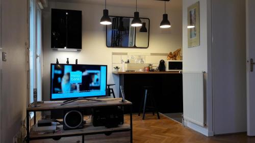 un salon avec une télévision sur une table dans l'établissement Superbe studio avec terrasse, à Courbevoie