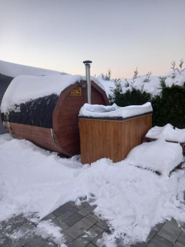 a hot tub covered in snow with snow around it at Apartamenty Happy & Relax in Bielsko-Biala