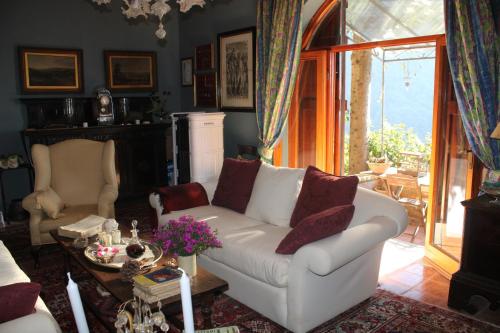 a living room with a white couch and a table at Casa Ceri in Casoli